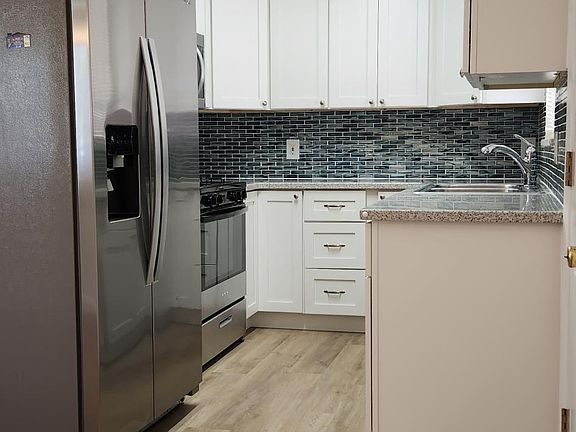 Plenty of counter space and tall upper cabinets allows for lots of storage spaces,