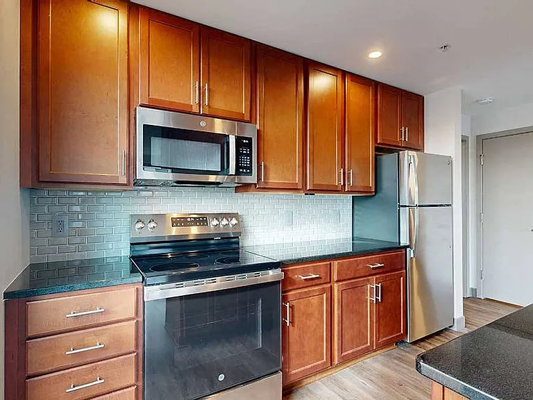 A modern kitchen with rich cabinetry and sleek finishes makes every meal feel like an experience.