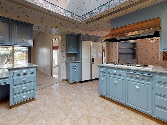The eye-catcher in this kitchen is it's beautiful copper range hood!