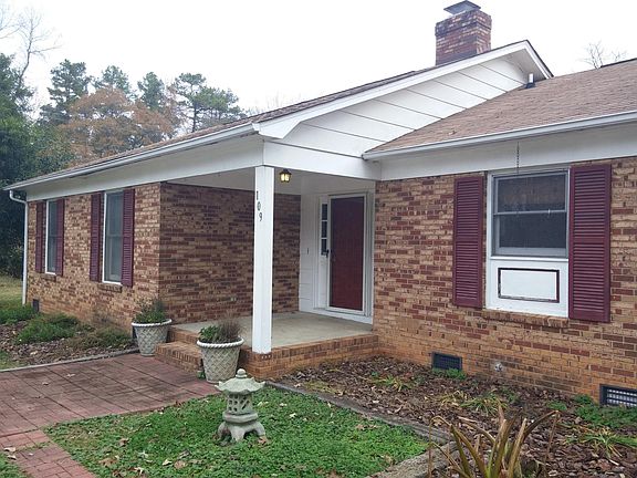 Nice covered front porch overlooks garden areas.