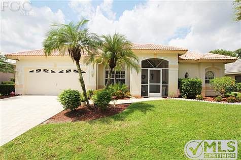 Gorgeous curb appeal with 2 and 1/2 car garage, screened entrance, and well maintained landscape.