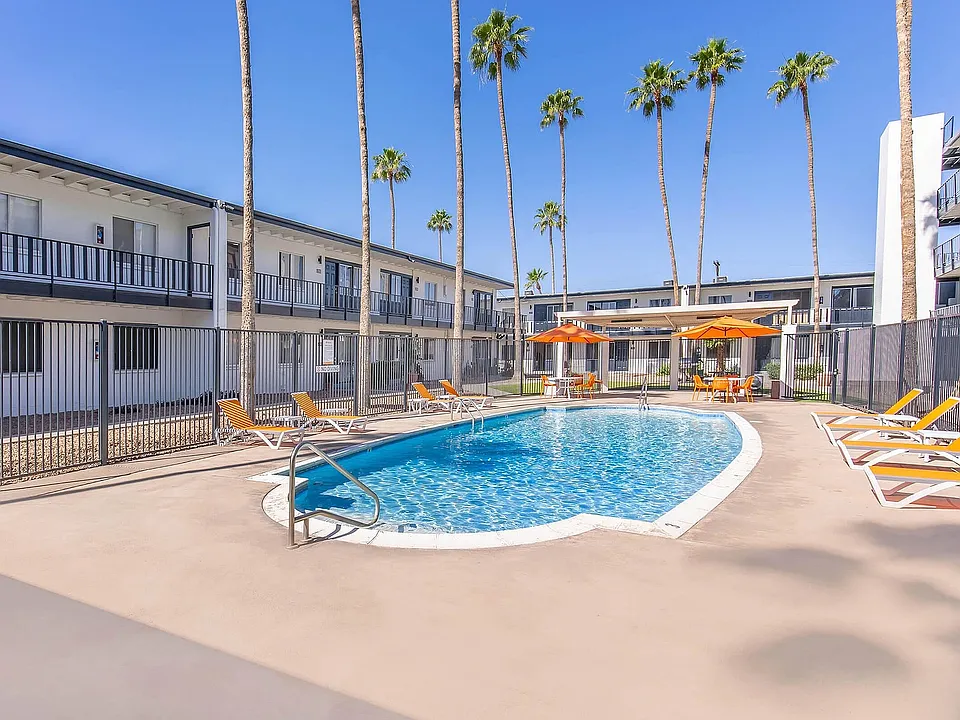 Courtyard pool with sun loungers and palm trees