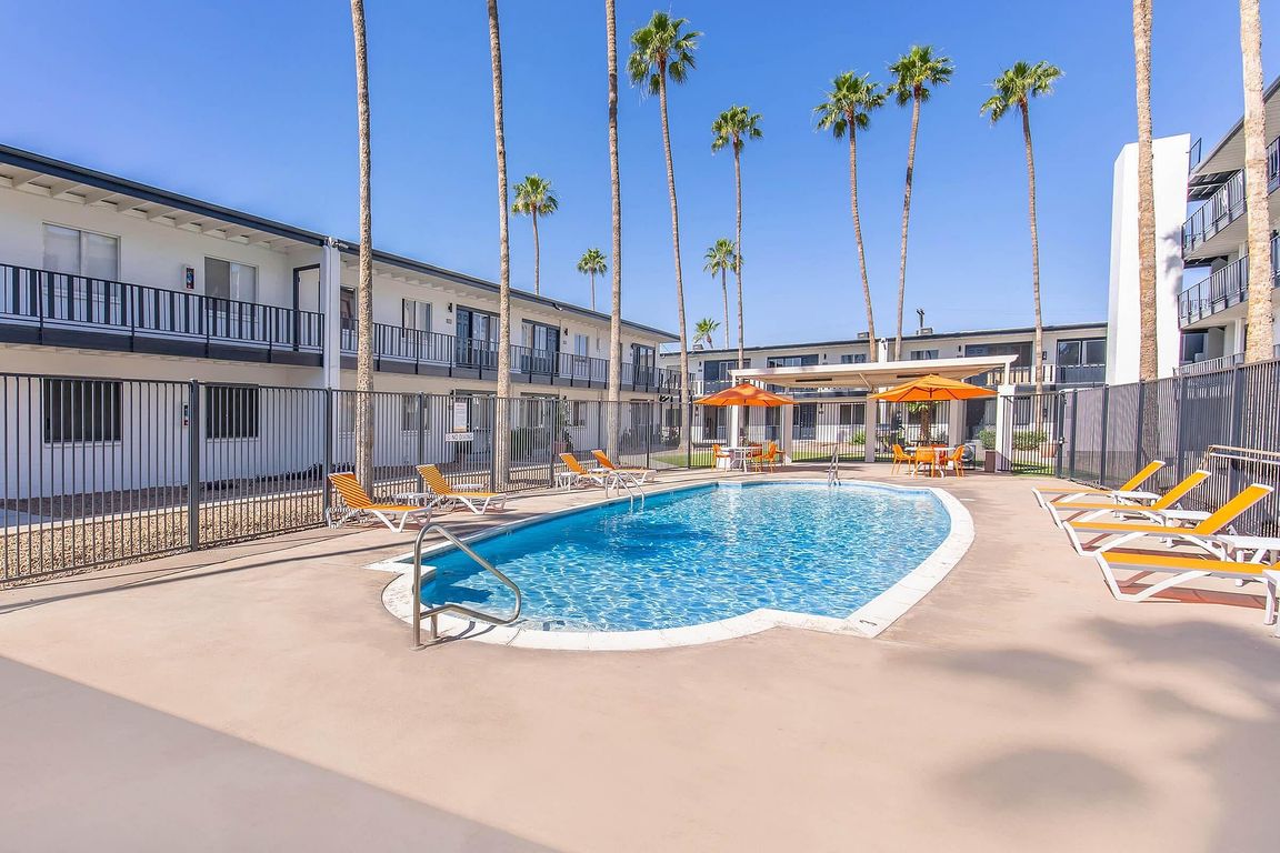 Courtyard pool with sun loungers and palm trees