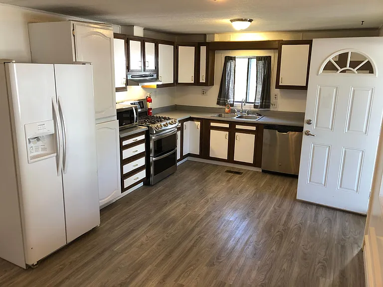 Large kitchen and dining room with new gas cooktop, 2 ovens, double sink, dishwasher, large refrigerator and freezer, and lots of cabinet space.