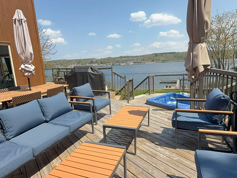 Deck with hot tub and lake view