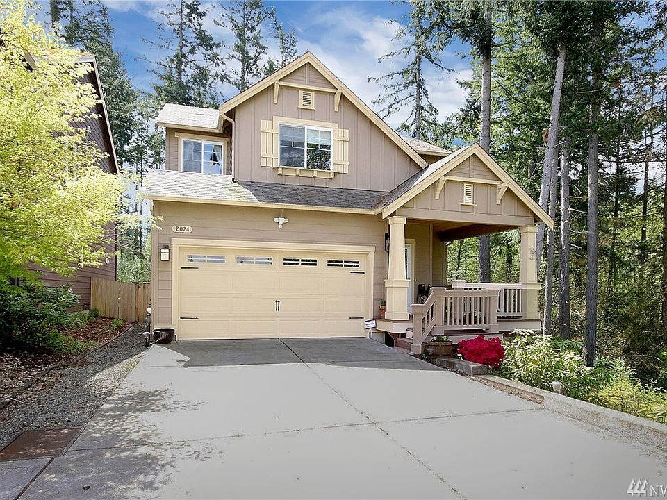 Beautiful 2 story home nestled in a peaceful treed setting! 3 bedrooms, 2.5 baths, 2 car garage w/ AC, security system, extensive hardwoods, private backyard & more!