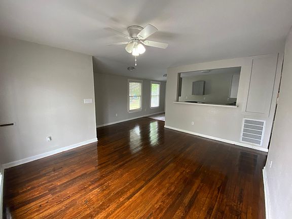 Living room looking towards kitchen, solid oak wood floors.