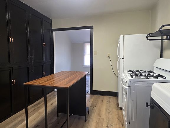 Galley Style Kitchen, microwave shelf above the stove. Full wall of cabinets TONS of storage.