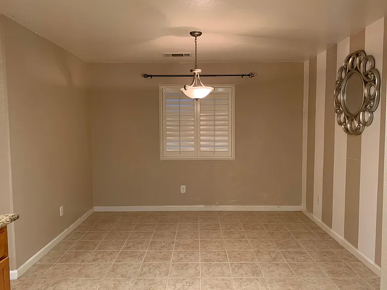 Dedicated dinning room adjacent to kitchen. Accent wall makes a nice statement to guests.