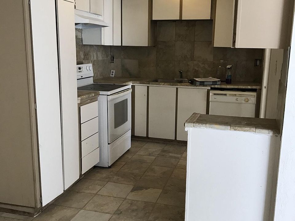 Glass top stove, dishwasher with granite countertop and floo