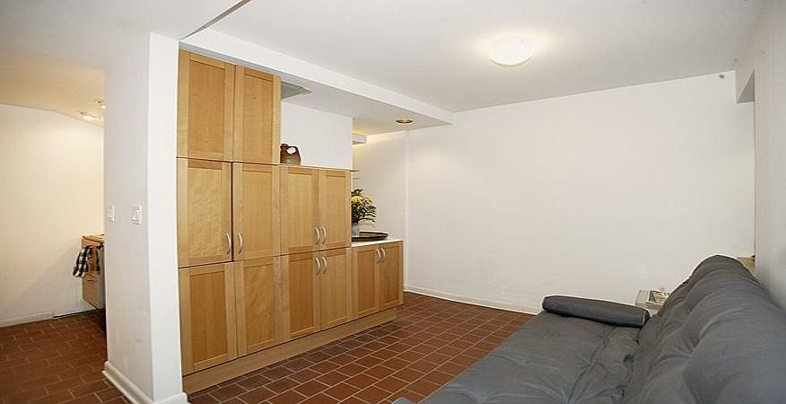 Living area (Note: studio is rented unfurnished, without these shelves)