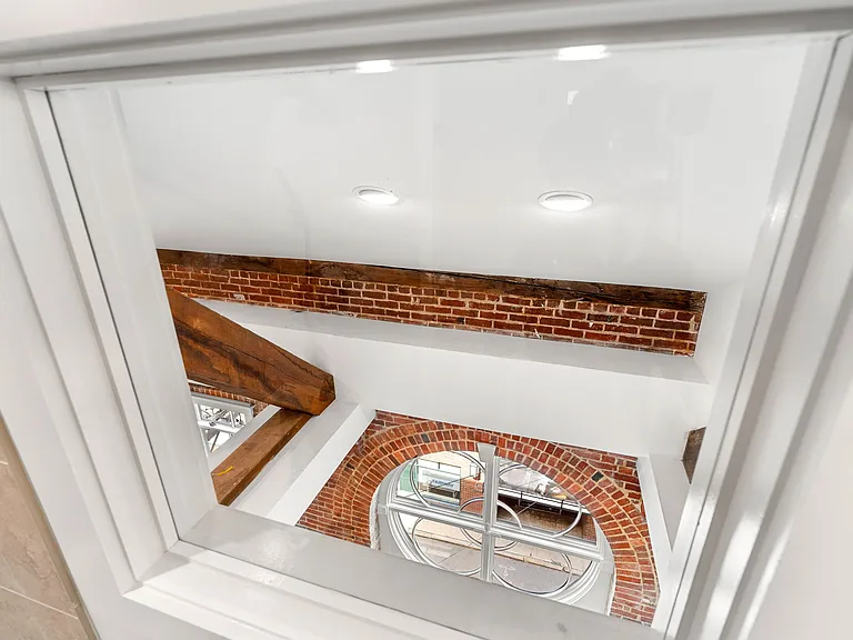 View from Penthouse bathroom thru 7' circular window on the floor below and out to downtown!