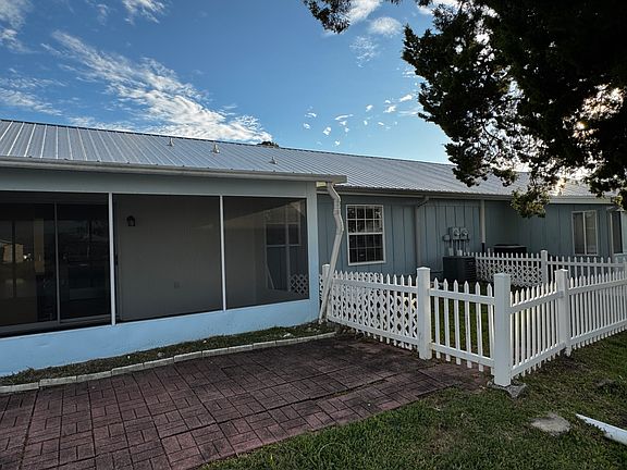 fenced backyard with pavers for BBQ