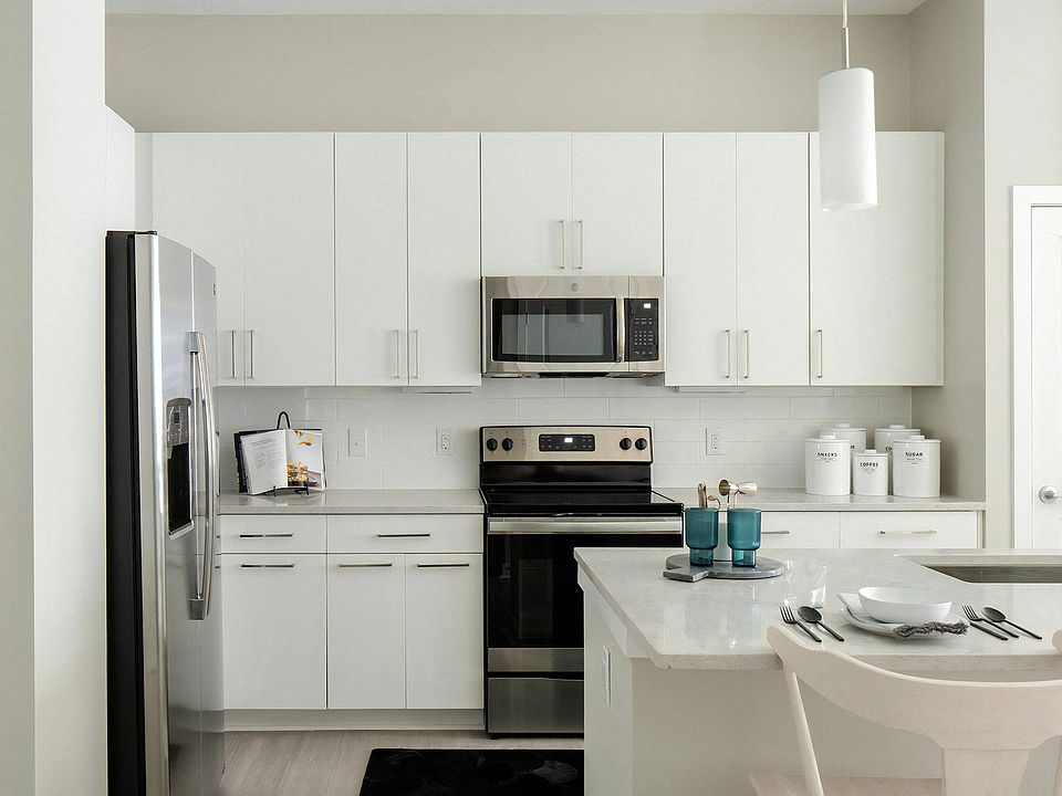 Open Kitchen Design Featuring Overhead Cabinets, Bar Counter, and Flat-Front Drawers