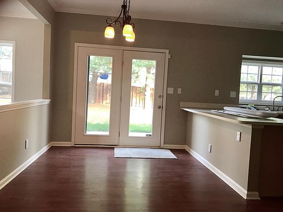 Breakfast area looking out to treed, fenced backyard.