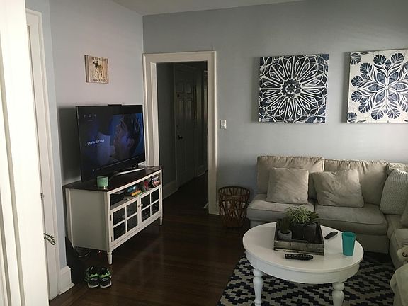 Living room with view to hallway to bedroom and kitchen.