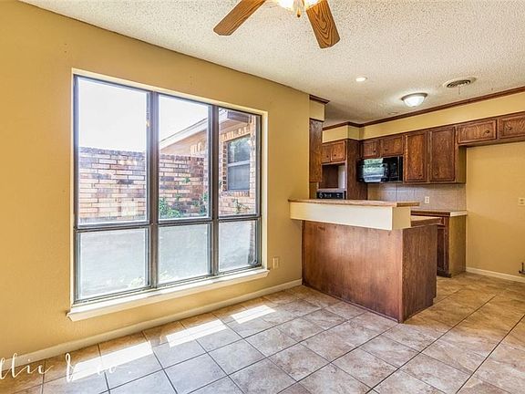 Dining space is open to the kitchen. Large windows bring in lots of natural light to this area.