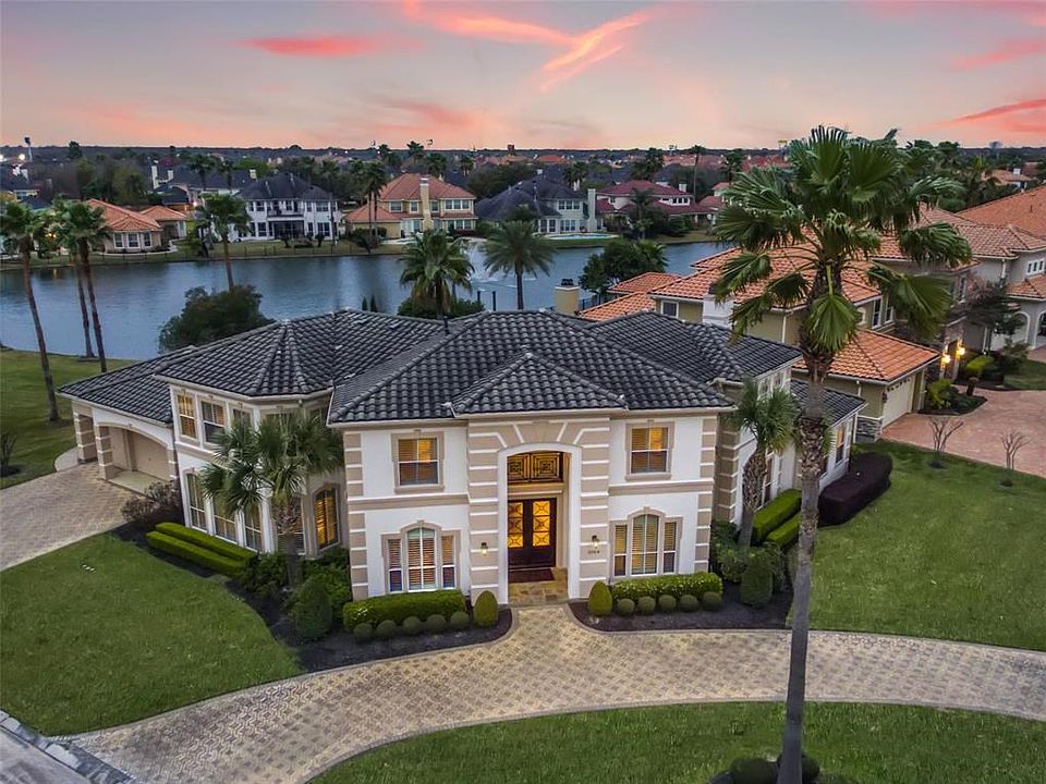 Stunning lake front Mediterranean style features 5/3.5 in Lakes of Parkway.