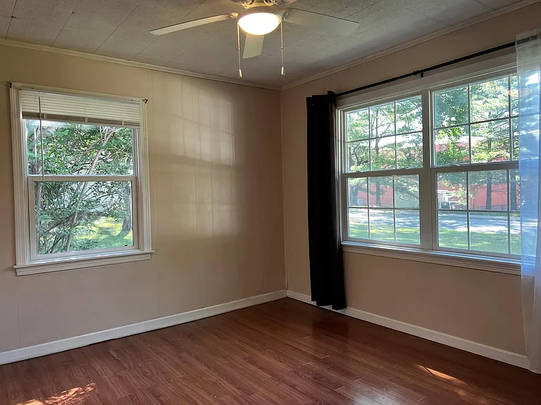 Bedroom number one with large newer windows and closet.