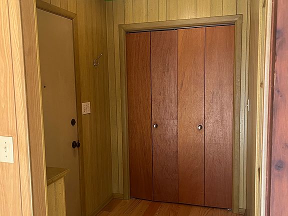 Foyer entrance with closet and storage shelving