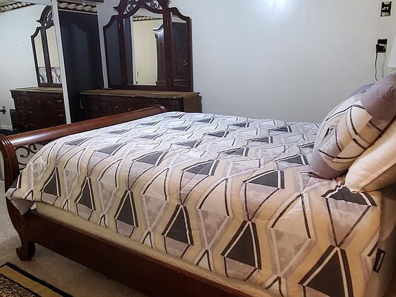 Large Bedroom with Queen size Slay bed, with granite top dresser, night stand and chest