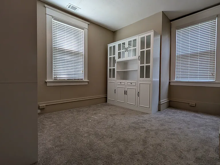 Walk-in closet complete with two storage dressers.