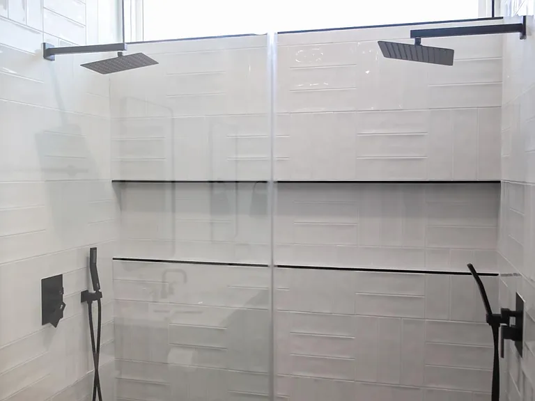 Primary main walk-in shower with dual overhead and removal shower heads.