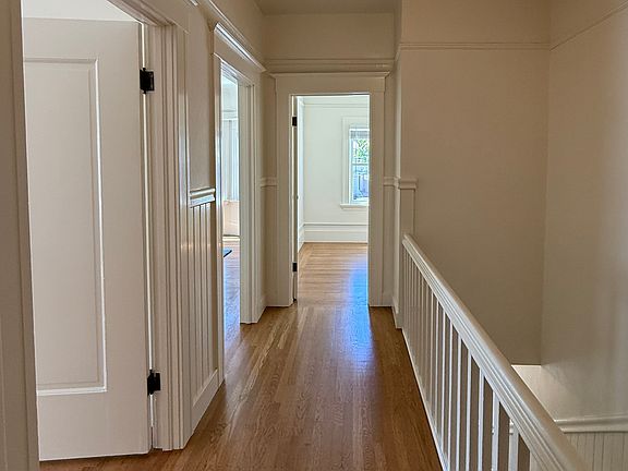 Hallway looking toward the front of the unit (office straight ahead, living room and main bedroom on the left, staircase on the right)