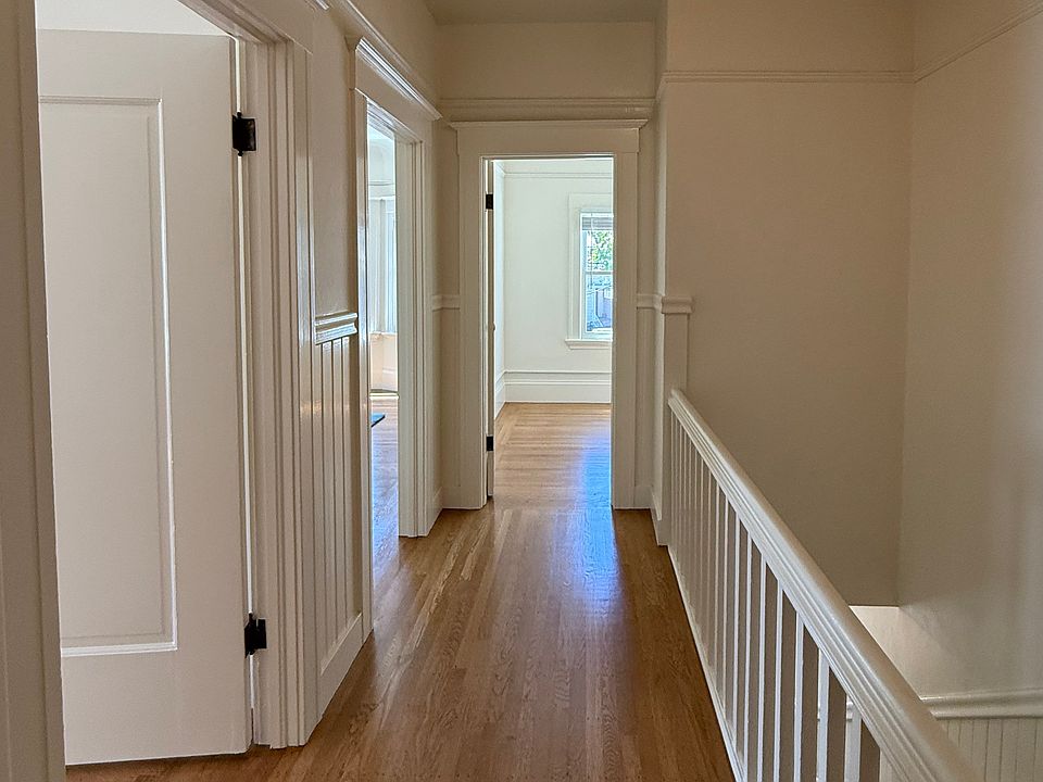 Hallway looking toward the front of the unit (office straight ahead, living room and main bedroom on the left, staircase on the right)