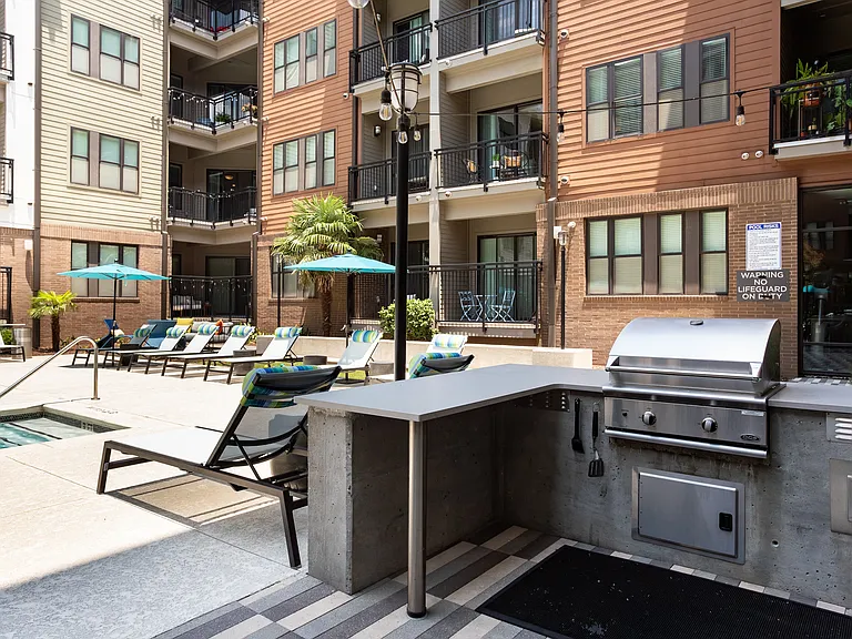 Outdoor Community Grilling Station with Bar Seating by the Pool