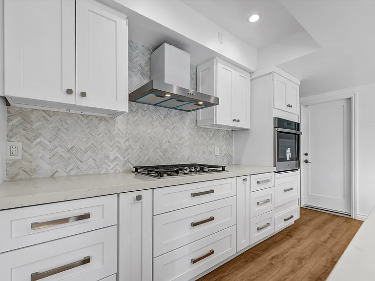 Kitchen - view of stove, range hood, and oven