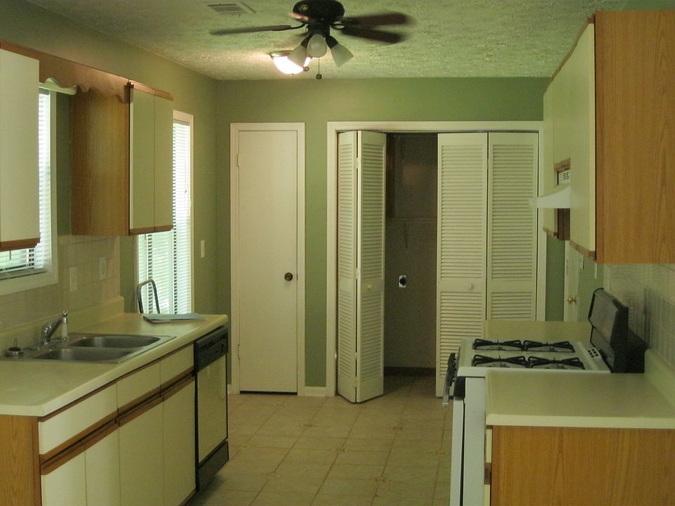 Kitchen with pantry and washer/dryer.