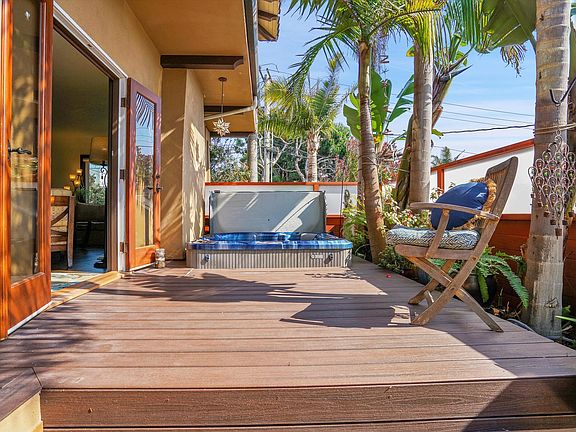 View of patio area and jacuzzi off the living room