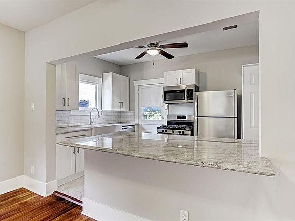 View of kitchen and newly added counter (previously was a wall)