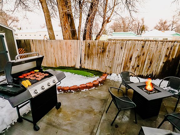 An inviting outdoor table situated near the BBQ grill, perfect for enjoying freshly grilled meals in the beauty of the outdoors.