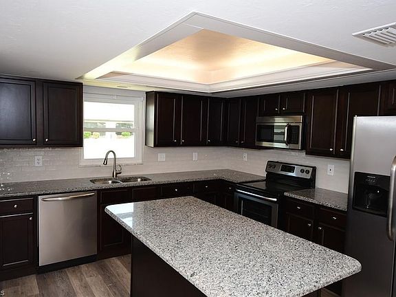 Walk in the front door and view this incredible remodeled kitchen which includes an island workspace and additional seating at counter if you wish.