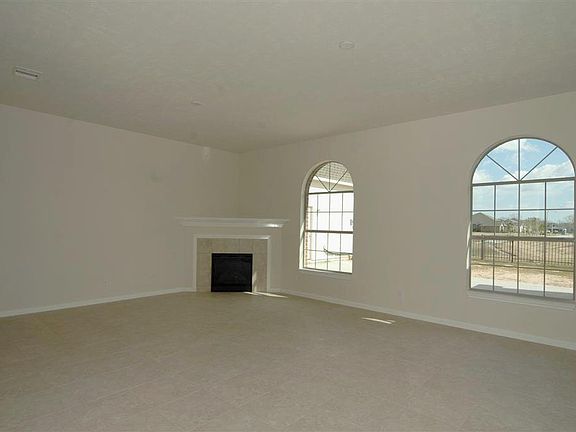 Large family room features gas fireplace and is open to the kitchen. Great for entertaining!