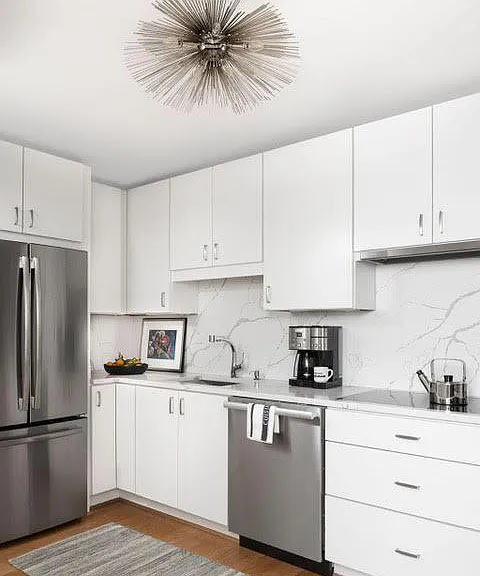 Modern kitchen with designer lighting and cabinetry