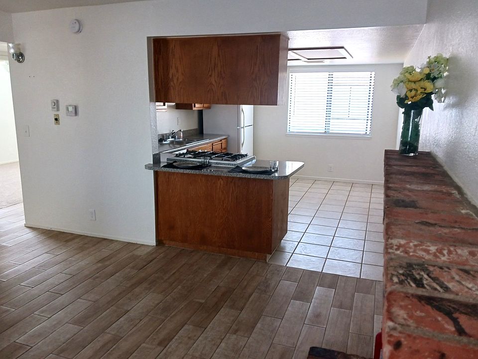 Living room, kitchen and dining area with fireplace.