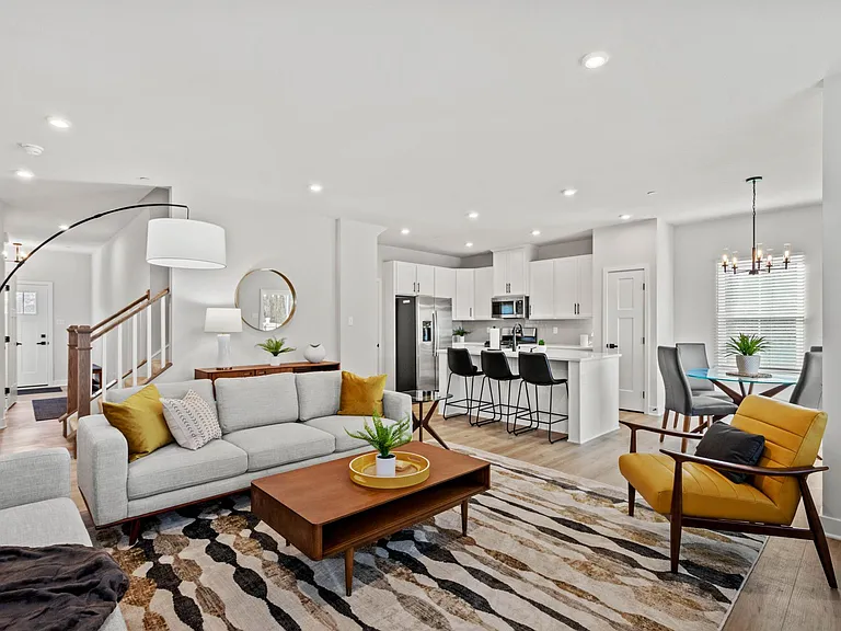 Open concept great room is styled with mid-century modern decor