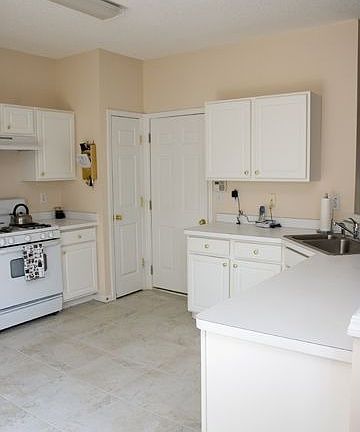 The open kitchen has plenty of counterspace, cabinets, and 2 pantries