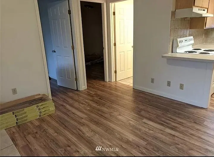 Living room space with Luxury Vinyl Plank flooring and new doors.