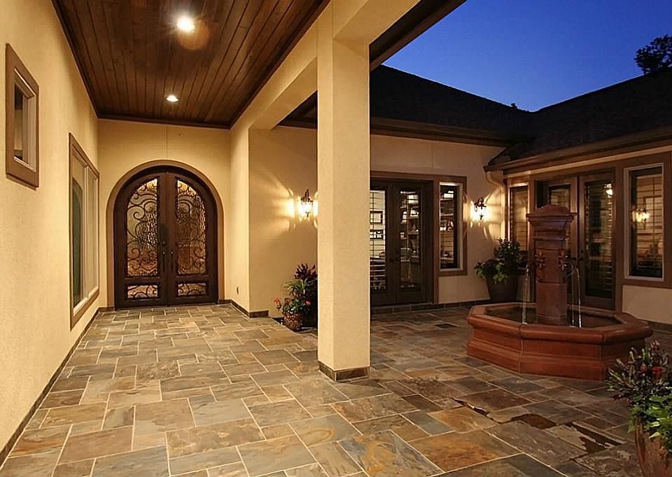 The notable pine beadboard ceilings and natural slate floors highlight the entrance into the courtyard. It provides privacy and a great area for outdoor entertaining.