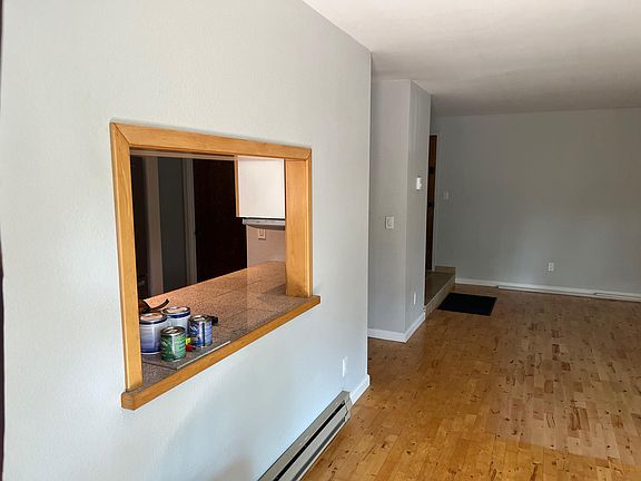 Living/dining room with pass-through window to kitchen