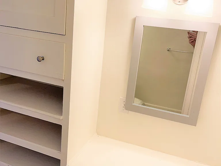 Vanity and built ins outside of bathroom in its own hallway away from main room