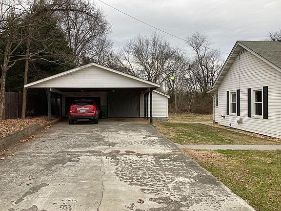 Carport and Garage with work room and storage room