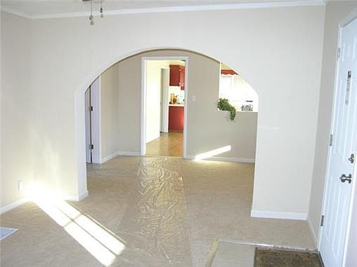 Living room open through the arch to the dining area. With such a large kitchen this dining area wou