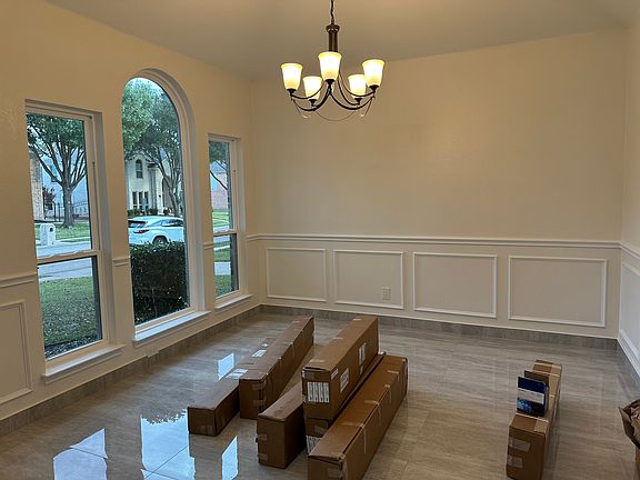 Formal dining room in front of house with boxes of new blinds ready to install.