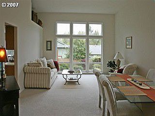 Formal living area features 12 foot ceilings, and beautiful backyard views