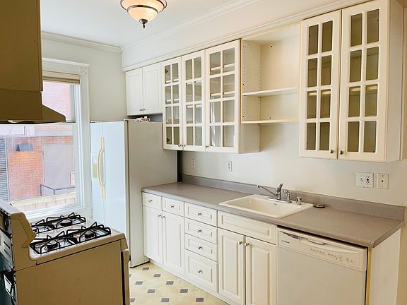Kitchen features dishwasher, gas range and side by side refrigerator